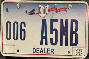 Ein Nahaufnahme eines Autoschilder mit Text und Zahlen.