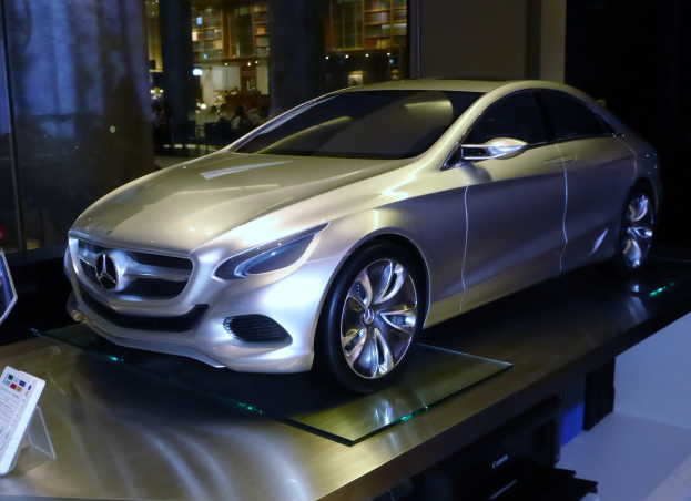 Mercedes-Benz-Konzeptfahrzeug mit glänzendem schwarzen Lack und Chromakzenten auf einem Podium auf der Frankfurter Motor Show ausgestellt, mit Menschen und Beleuchtung im Hintergrund.